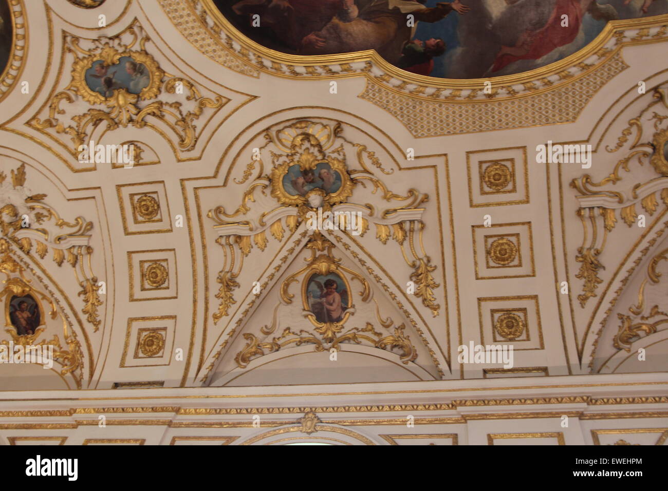 Church Organ gold pipes and Artwork religious painting of the ceiling of the church Stock Photo