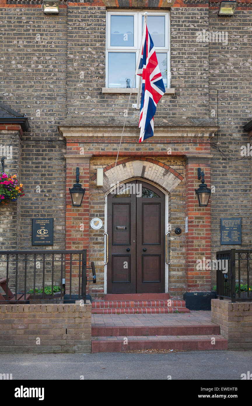 Union Jack flag flying above entrance to Chelmsford Conservative Social Club main entrance Stock Photo