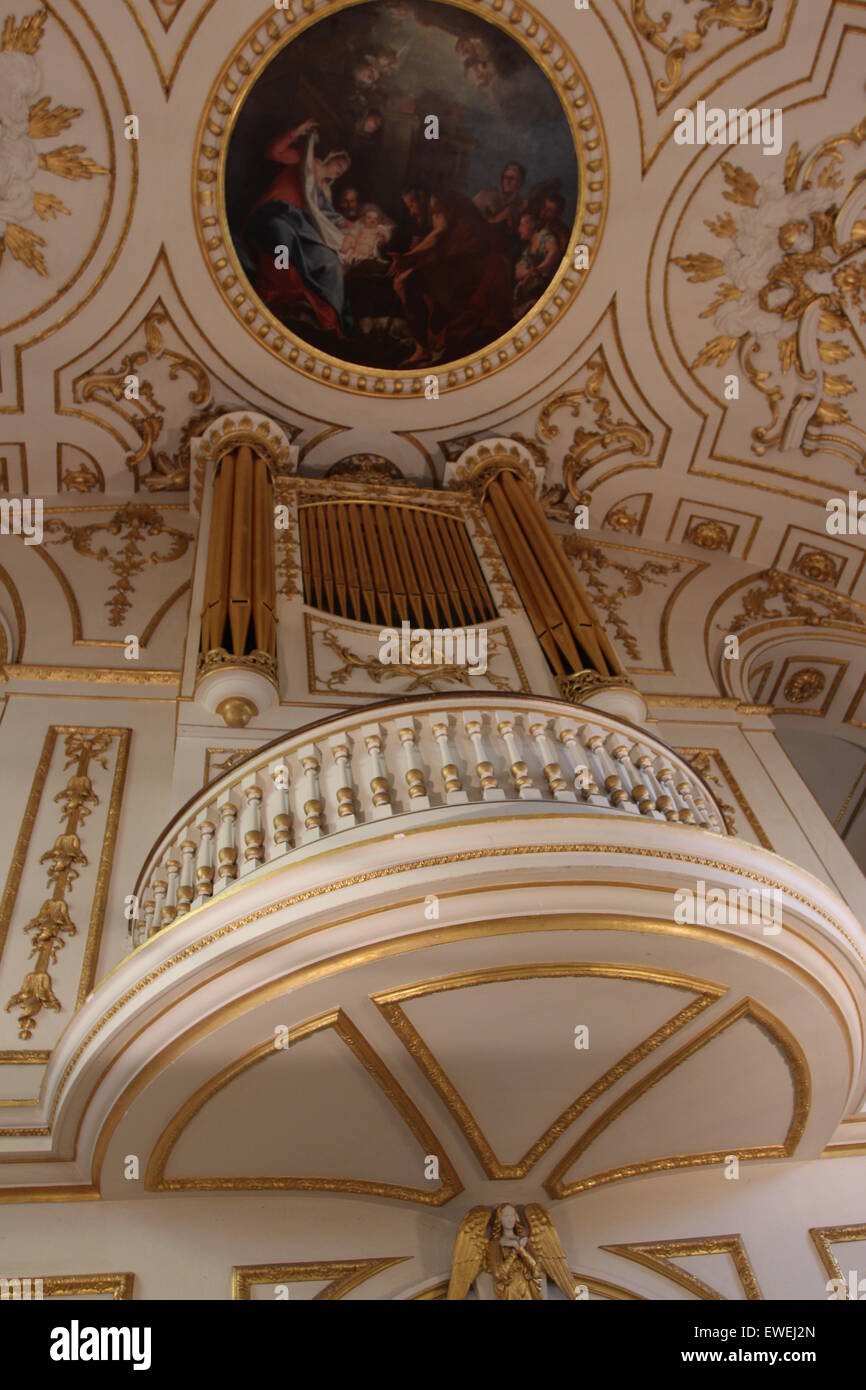 Church Organ gold pipes and Artwork religious painting of the ceiling of the church Stock Photo