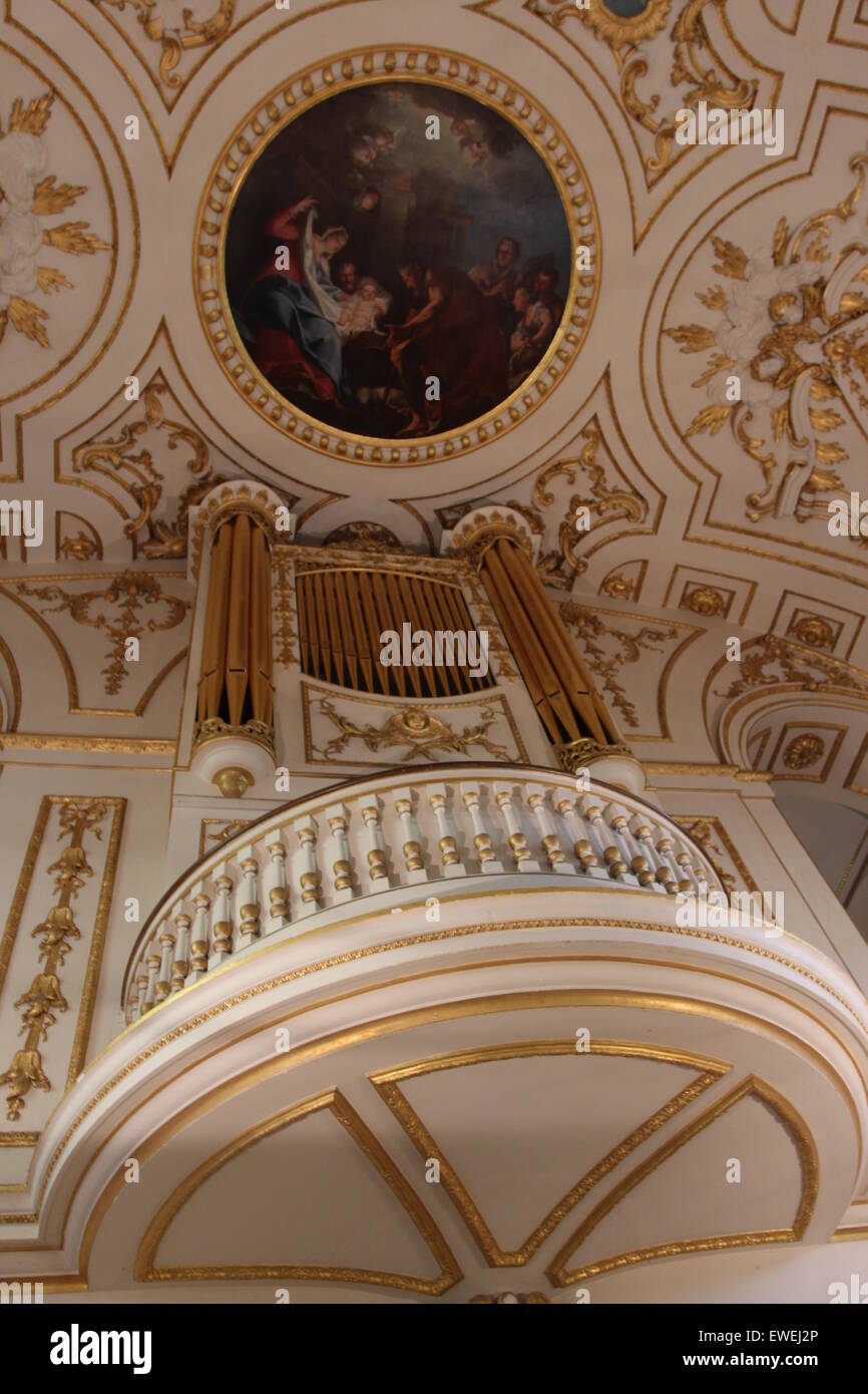 Church Organ gold pipes and Artwork religious painting of the ceiling of the church Stock Photo