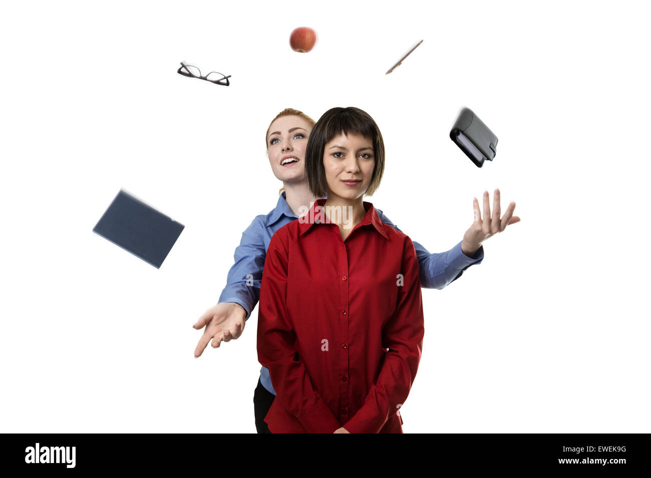woman standing behind another woman helping her to juggle objects Stock Photo Alamy