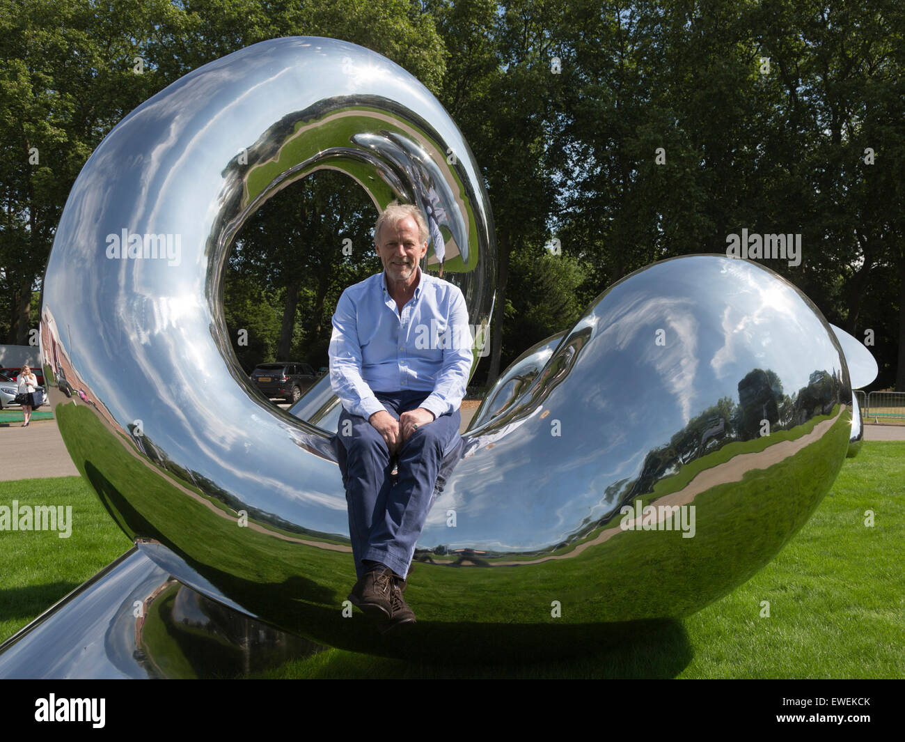 Sculptor Richard Hudson poses with his sculptures Adam & Eve outside