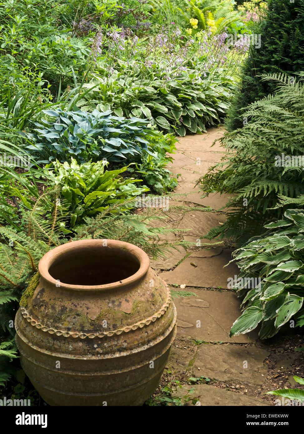 Garden path with borders and terracotta urn, Coton Manor Gardens, Coton, Northamptonshire, England, UK. Stock Photo