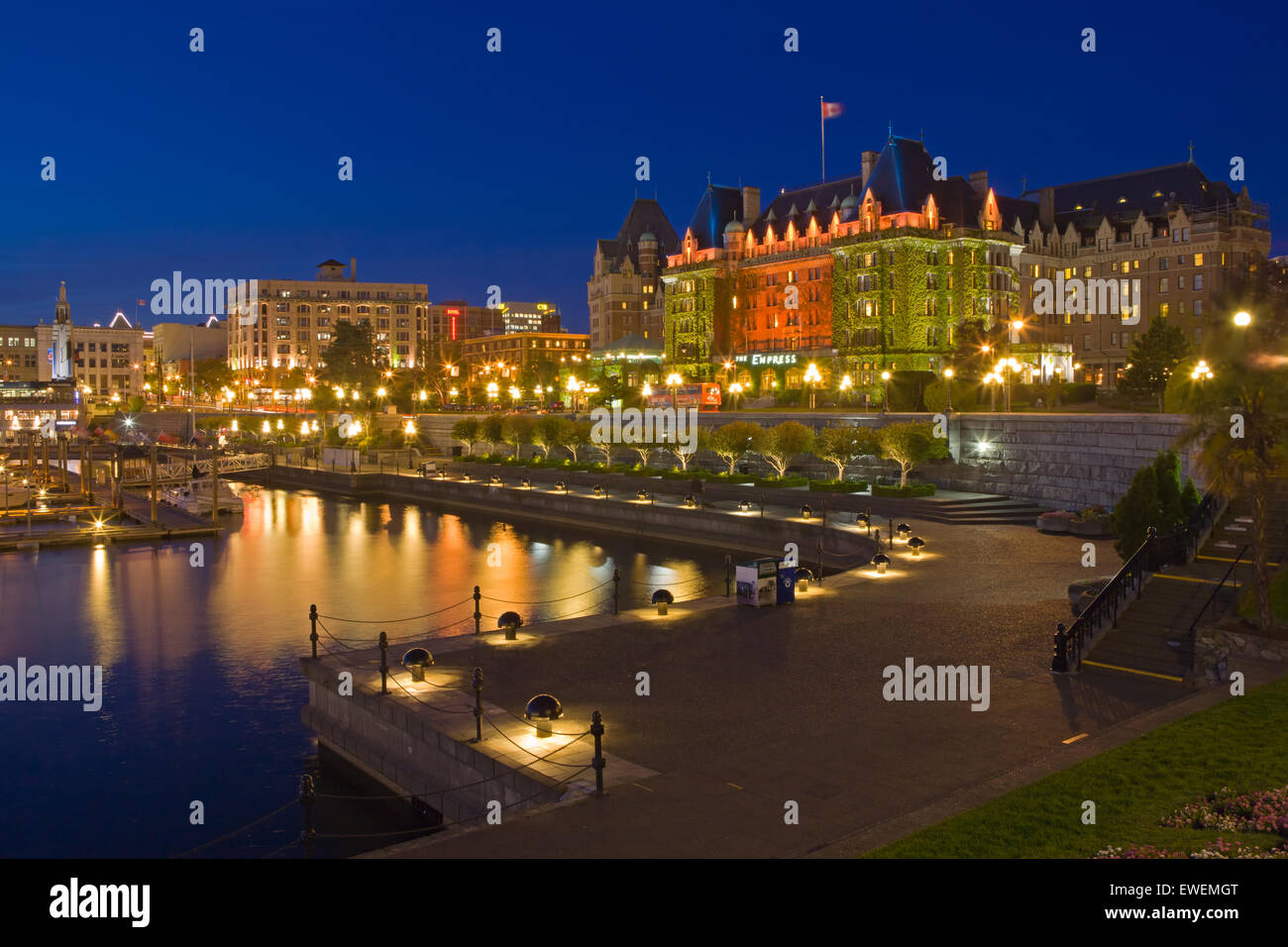 Illuminated Victoria's Inner Harbour with the landmark Empress Hotel (Fairmont Hotel) in the background at twilight, Victoria, V Stock Photo