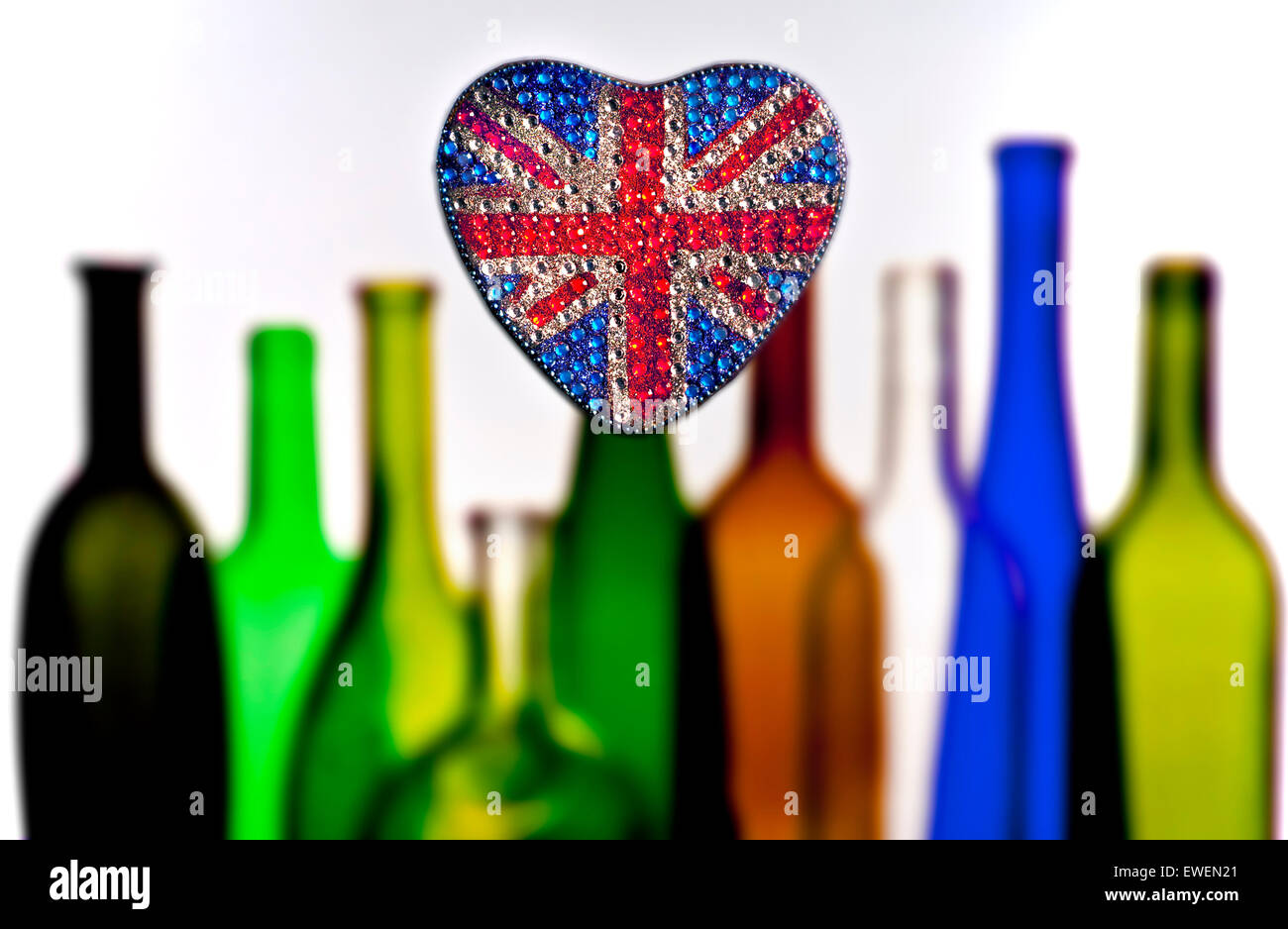 English wine concept with heart shaped reflective sparkling Union Jack Flag motif with colorful wine bottles behind Stock Photo