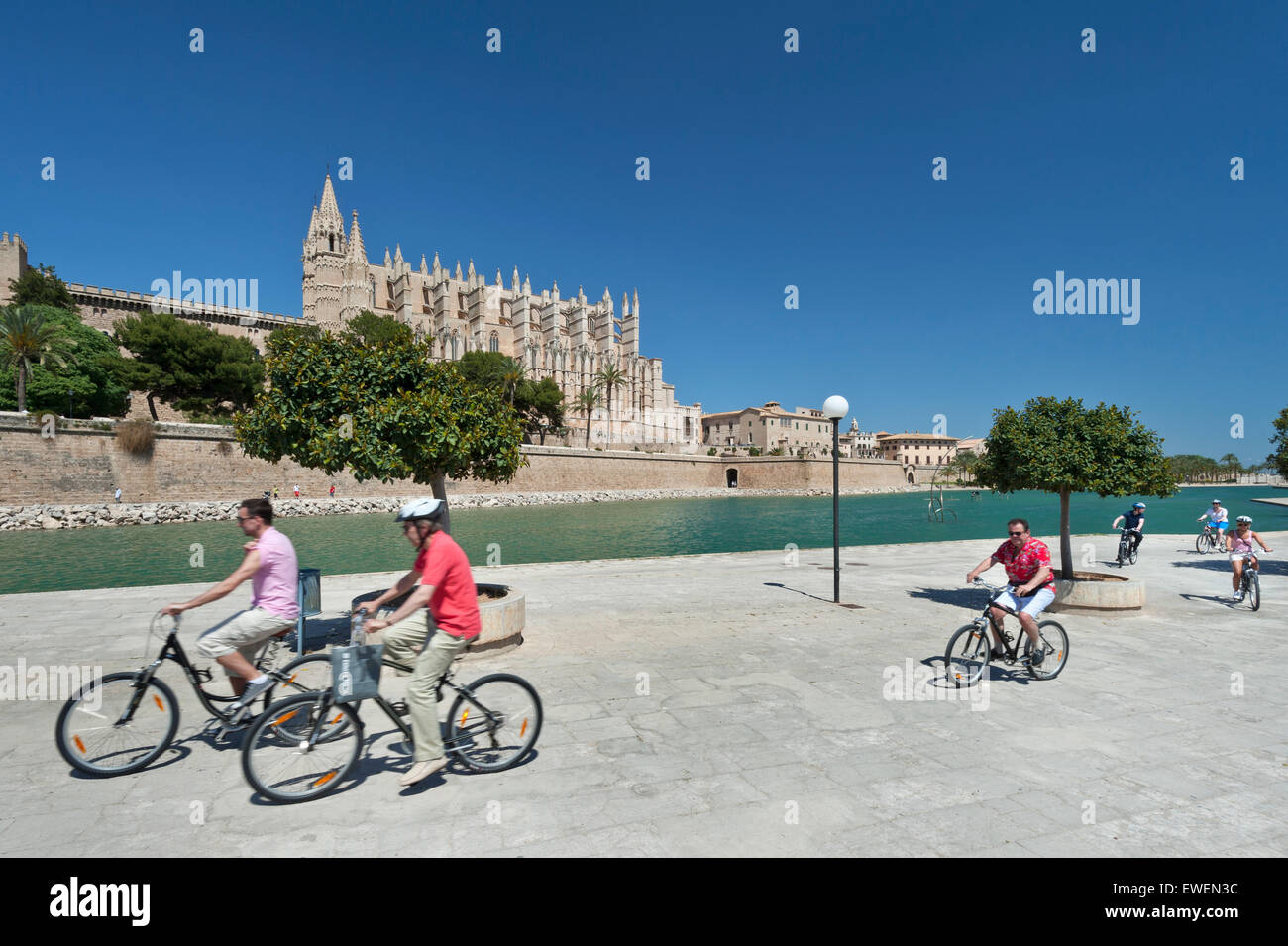 Palma Mallorca cycling tour group of cyclists riding near Palma Cathedral in Parc de la Mar Palma historic center Mallorca Spain EU Stock Photo