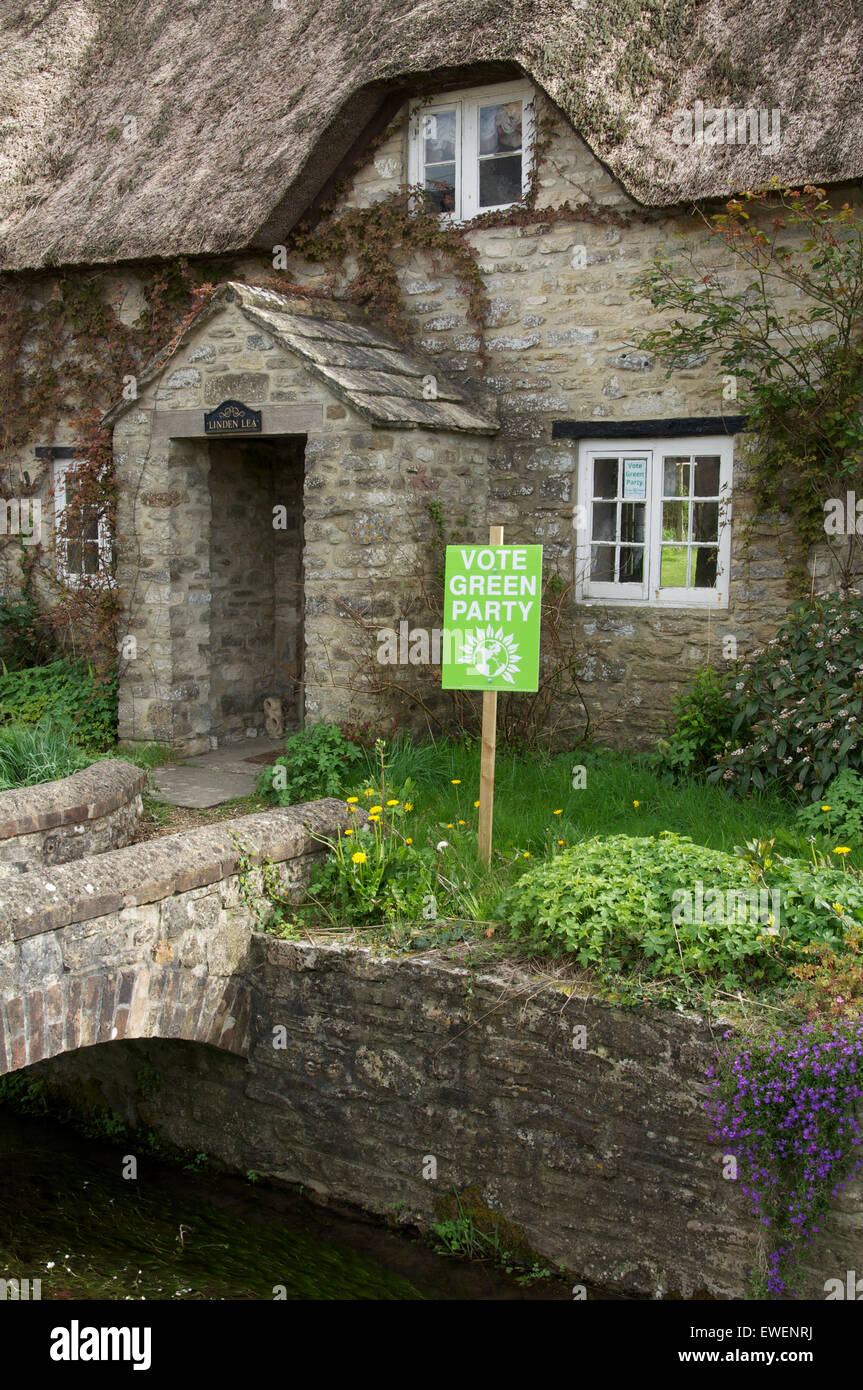 Vote green party. A political placard in a rural cottage garden supports the Green Party in the 2015 UK general election. Dorset, England, UK. Stock Photo