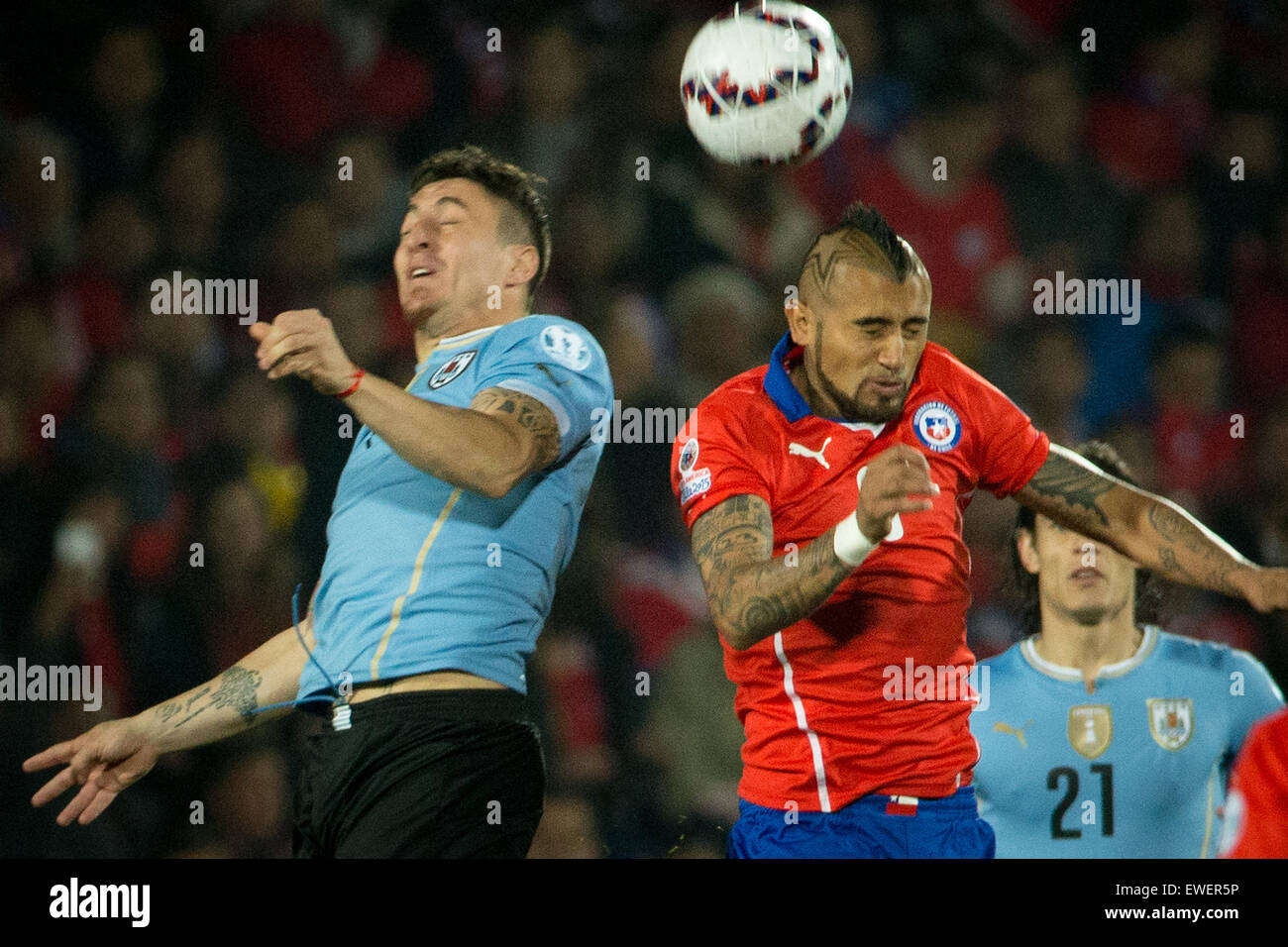 Santiago, Chile. 24th June, 2015. Arturo Vidal (R) of Chile fights for the ball with Cristian Rodriguez of Uruguay during their quarterfinal at 2015 Copa America in Santiago, Chile, on June 24, 2015. Credit:  Pedro Mera/Xinhua/Alamy Live News Stock Photo