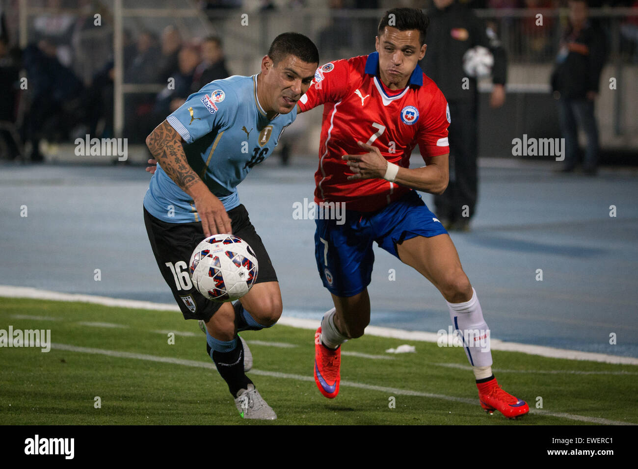 Santiago, Chile. 24th June, 2015. Alexis Sanchez (R) of Chile vies with Maxi Pereira of Uruguay during their quarterfinal at 2015 Copa America in Santiago, Chile, on June 24, 2015. Credit:  Pedro Mera/Xinhua/Alamy Live News Stock Photo