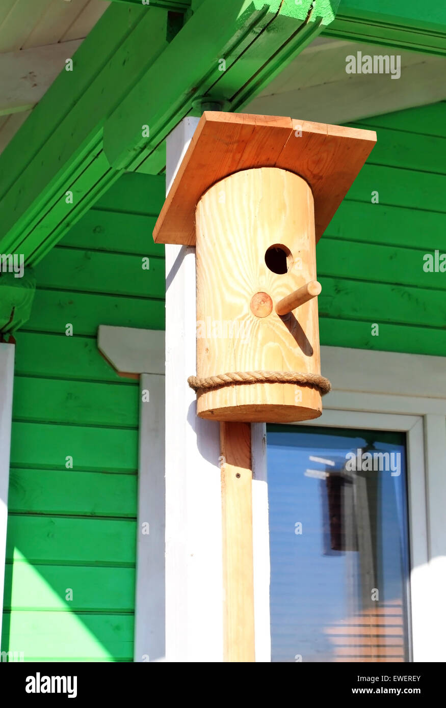 Wooden birdhouse on the terrace of the farmhouse Stock Photo