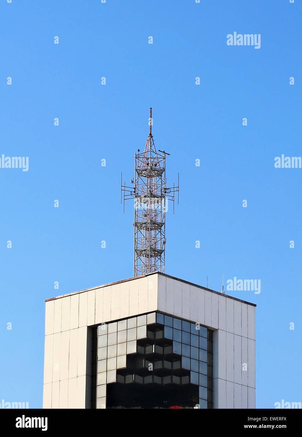 Metallic antenna on the roof of the high tech building Stock Photo