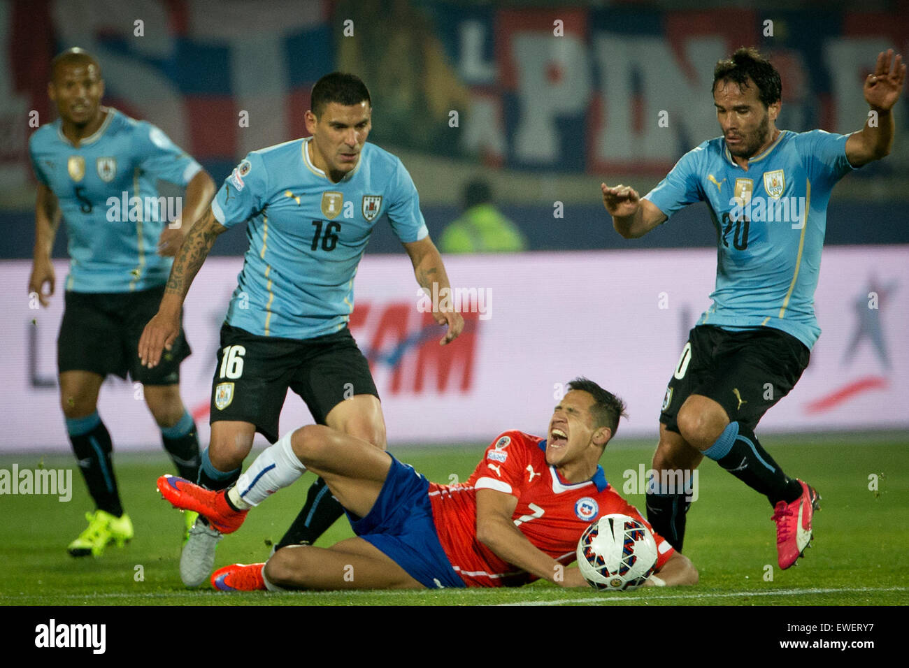 Santiago, Chile. 24th June, 2015. Alexis Sanchez (Bottom) of Chile vies with Maxi Pereira (L) of Uruguay during their quarterfinal against Uruguay at 2015 Copa America in Santiago, Chile, on June 24, 2015. Chile won 1-0. Credit:  Pedro Mera/Xinhua/Alamy Live News Stock Photo