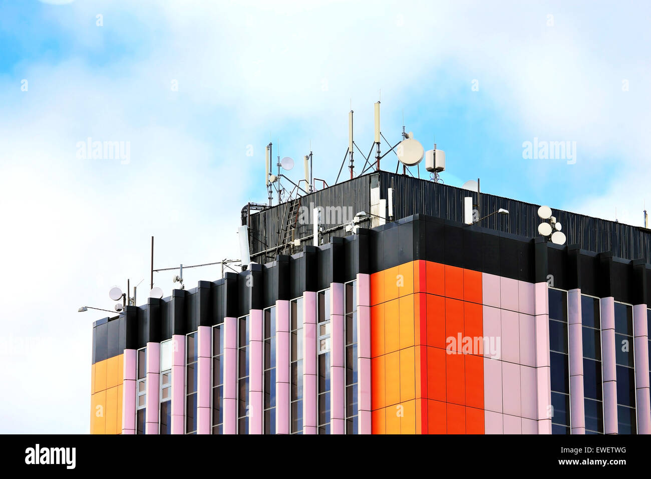 Ñellular communication units with microwave radio antenna equipment on the roof of an industrial building Stock Photo