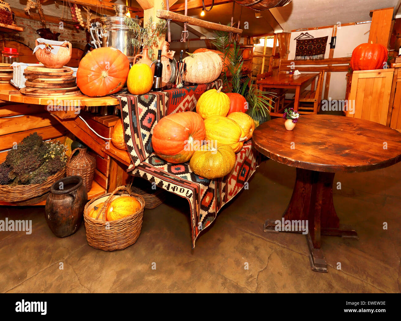 Interior of the country restaurant decorated with rural autumn vegetables Stock Photo