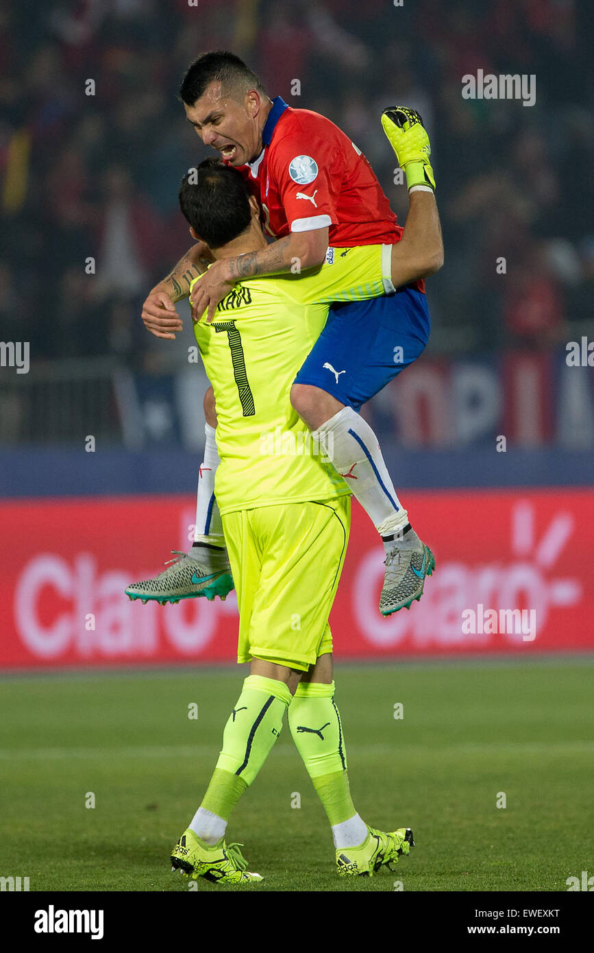 Santiago, Chile. 24th June, 2015. Chile's goalkeeper Edinson Cavani (Bottom) celebrates with his teammate Gary Medel after beating Uruguay during their quarterfinals at 2015 Copa America in Santiago, Chile, on June 24, 2015. Chile won 1-0. © Pedro Mera/Xinhua/Alamy Live News Stock Photo