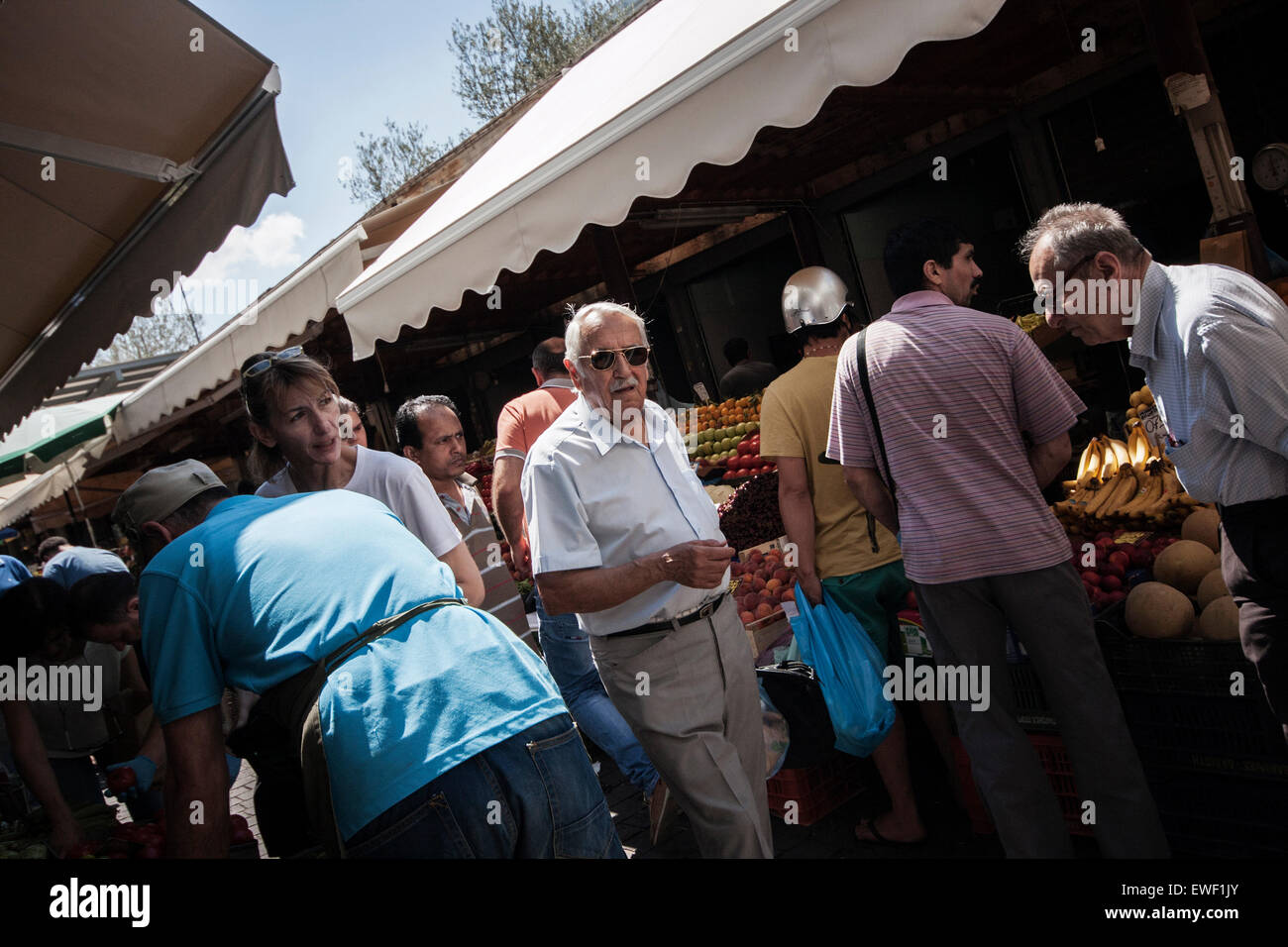 People buying staple food at the central market of Athens, Greece, 24