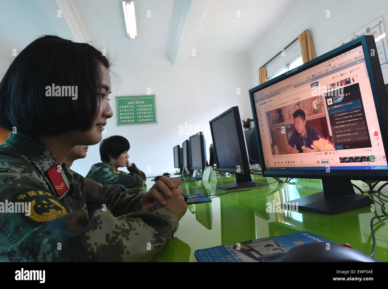 (150625) -- DEHONG, June 25, 2015 (Xinhua) -- Zhang Liu watches videos on the internet at the border checkpoint of Mukang in Dehong Dai-Jingpo Autonomous Prefecture, southwest China's Yunnan Province, June 24, 2015. Born in 1995, Zhang Liu became an anti-drug soldier in border checkpoint of Mukang in 2013.  Grown up in an affluent family in central China's Hunan Province, Zhang said that being a soldier had always been her dream, which drove her to join the army after graduating from high school. Being a front line anti-drug force, the border checkpoint of Mukang has captured about 100 kilogra Stock Photo