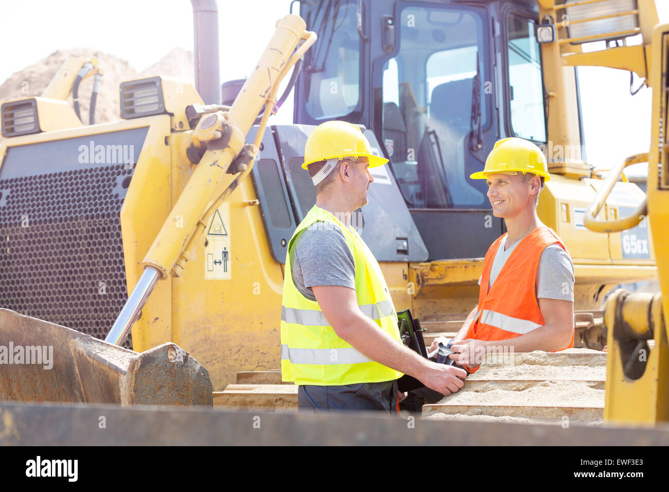 Engineers discussing at construction site Stock Photo