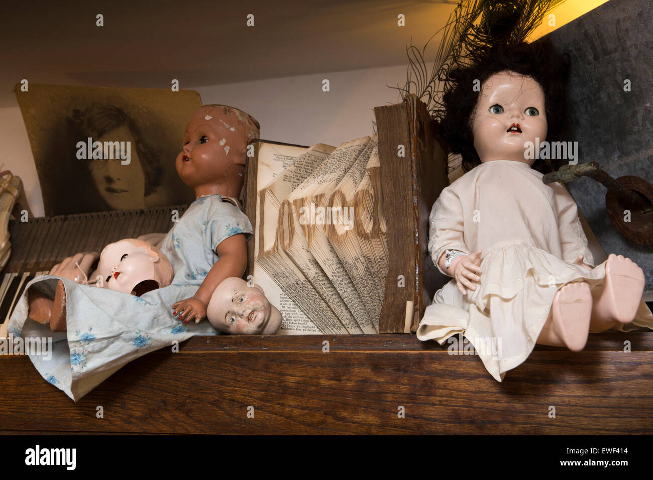 UK, England, Shropshire, Bridgnorth, Bank Street, A’tique shop, dolls and book folded into word ‘loved’ Stock Photo