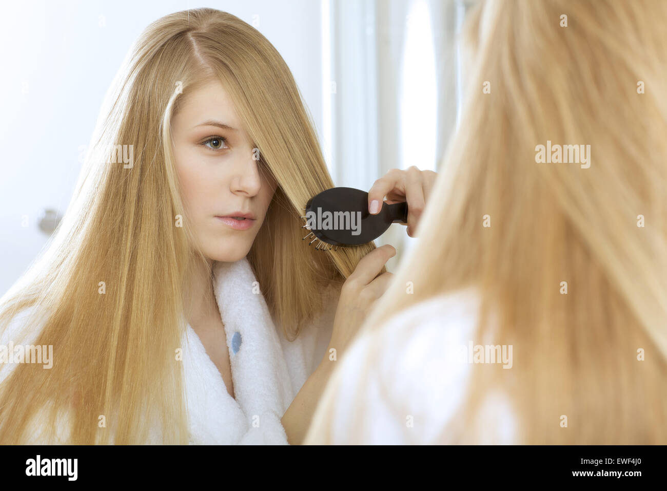 Woman brushing hair Stock Photo