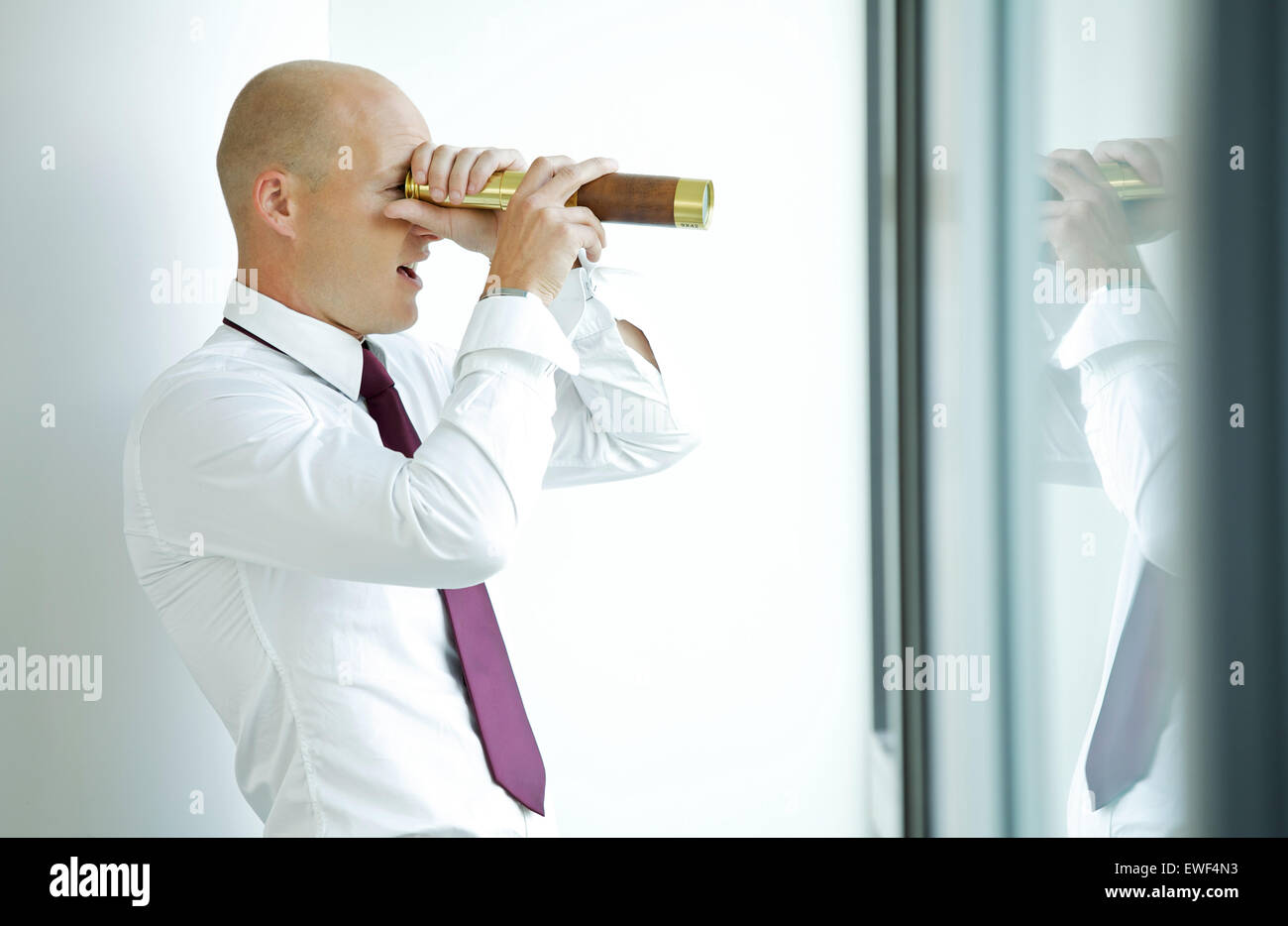 caucasian businessman spying using telescope thru office window Stock Photo Alamy