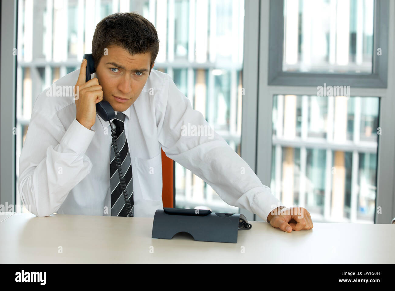 portrait of young confident caucasian businessman talking on phone Stock Photo