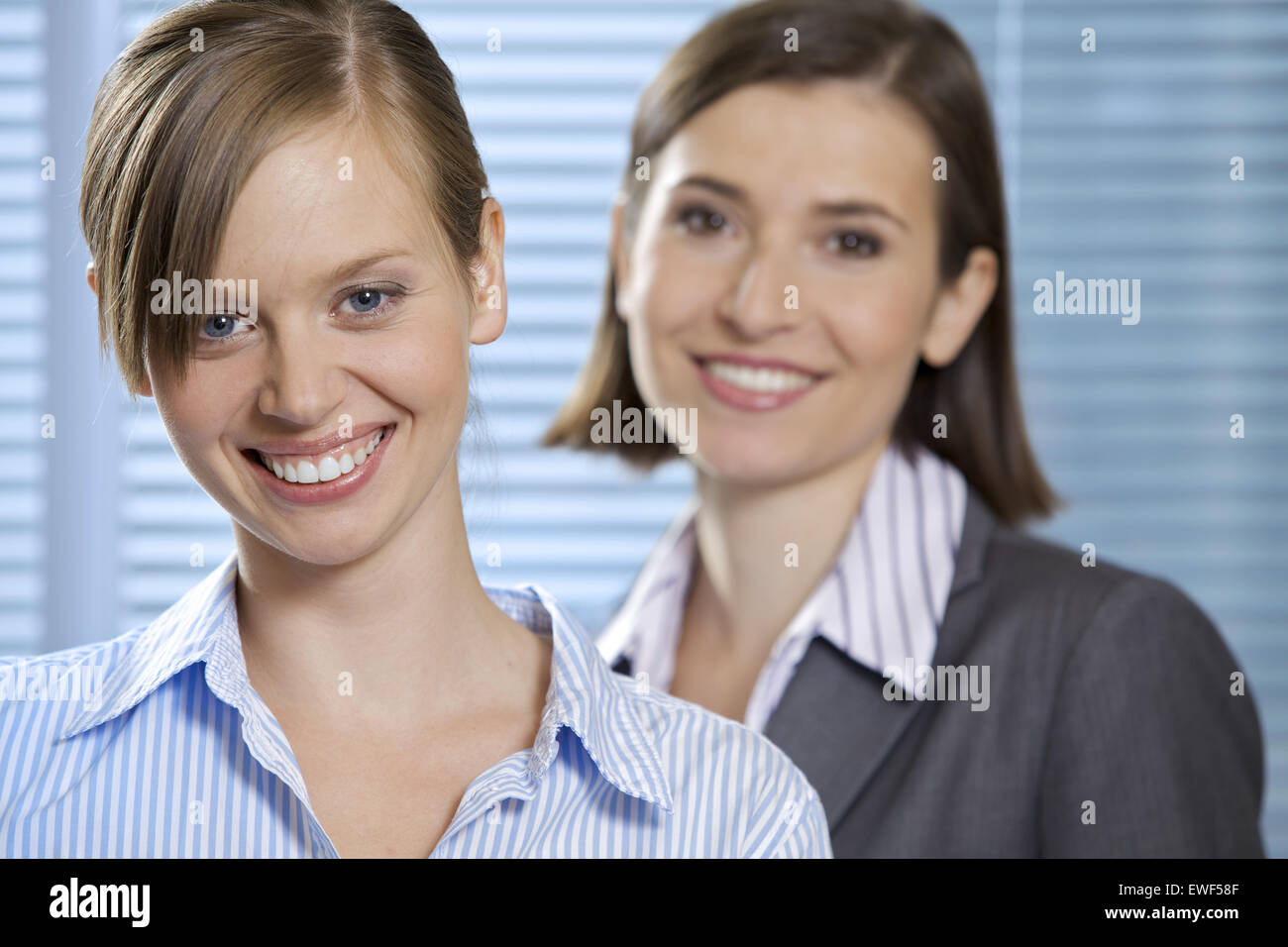 Portrait of smiling businesswomen in office Stock Photo - Alamy