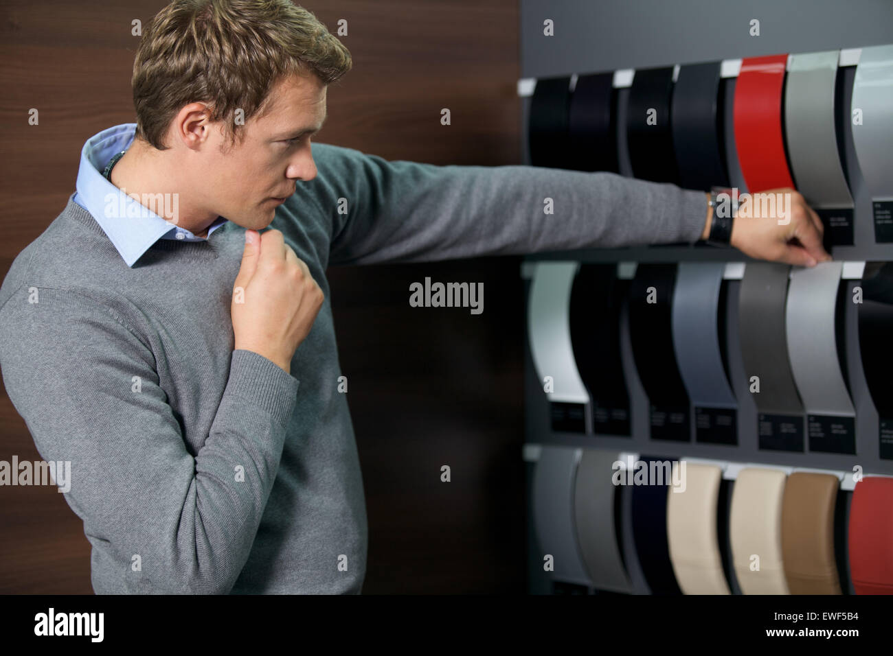 Young man looking at color swatch Stock Photo