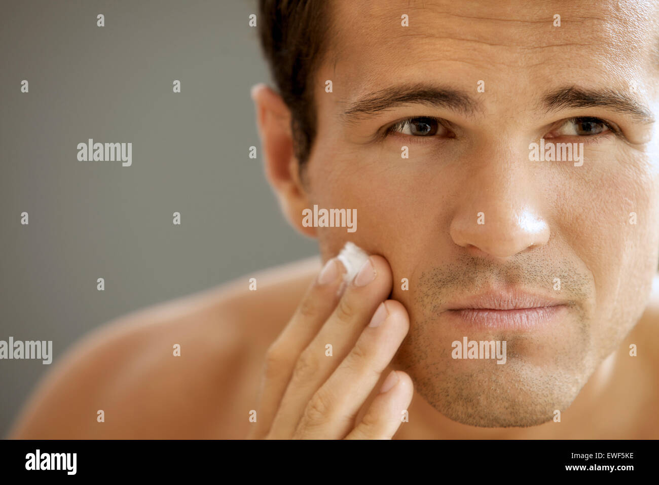 Close-up of young man applying shaving cream Stock Photo