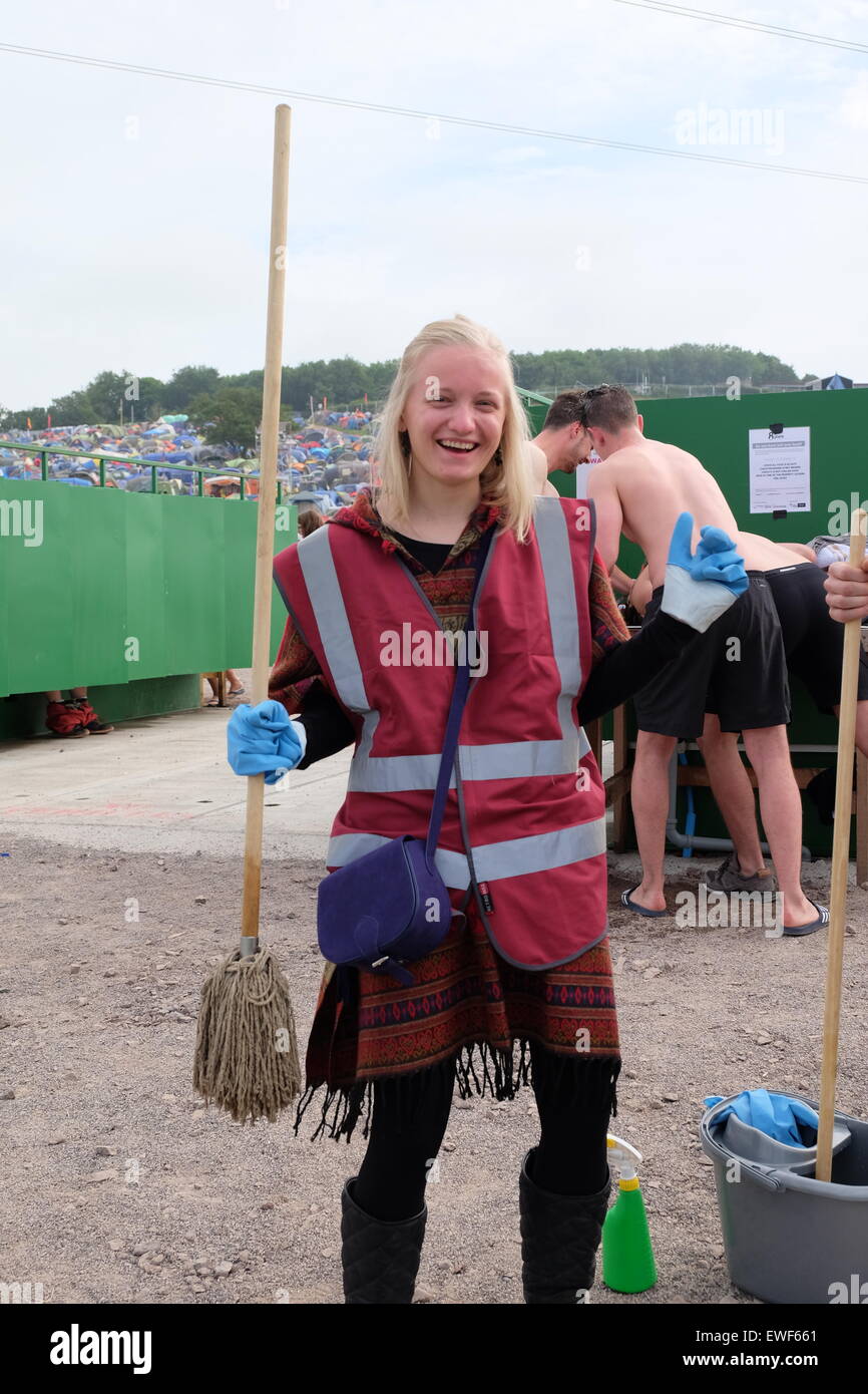 Glastonbury Festival, Somerset, UK. 25 June 2015. After a night cleaning the famed long drop toilets this cleaner does a happy dance as her shift ends. Credit:  Tom Corban/Alamy Live News Stock Photo