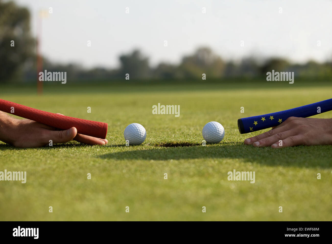 Human hands using golf balls to play pool Stock Photo