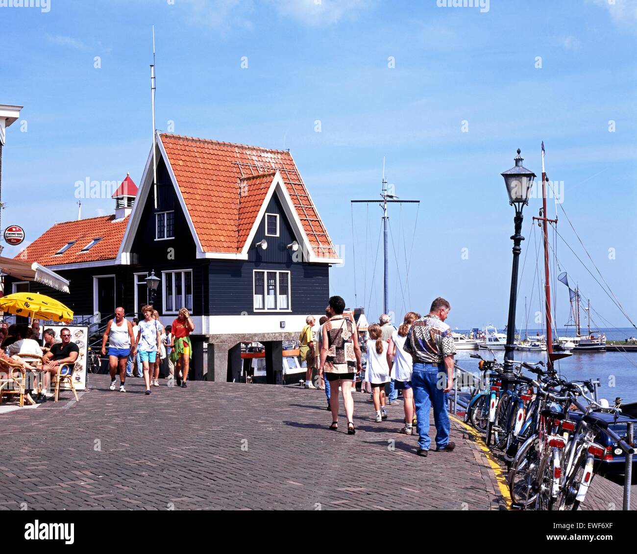 Tourists walking along the quayside street, Volendam, Holland, Netherlands, Europe. Stock Photo