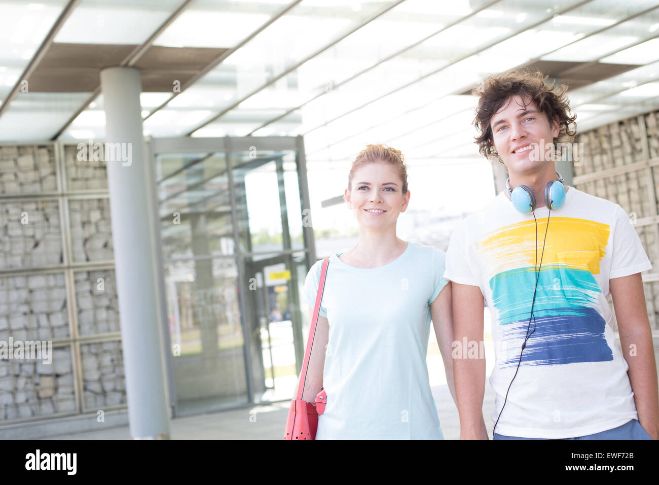 Smiling couple looking away while standing in city Stock Photo