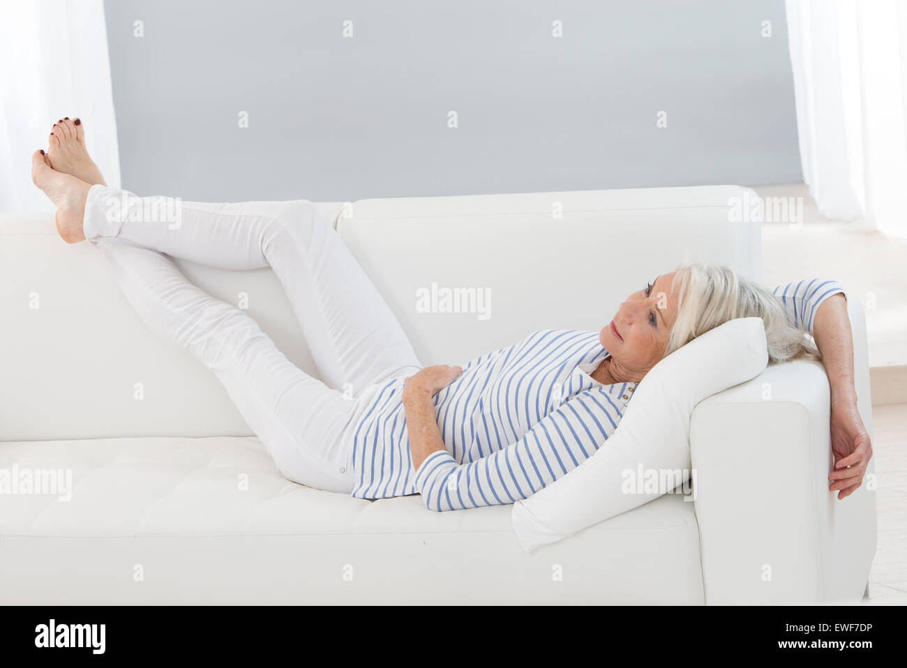 Older woman relaxing sofa hi-res stock photography and images - Alamy