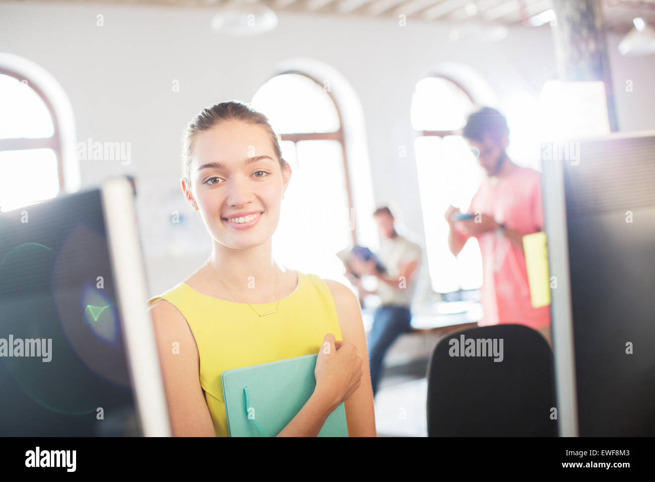 Portrait smiling businesswoman at computer in office Stock Photo - Alamy