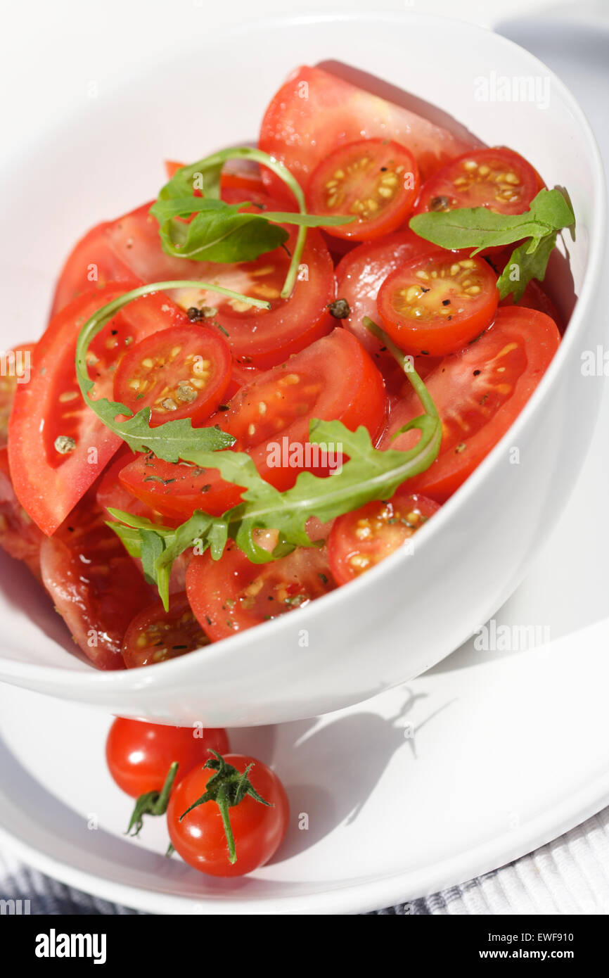 Close  - up of sliced tomatoes with rucola Stock Photo