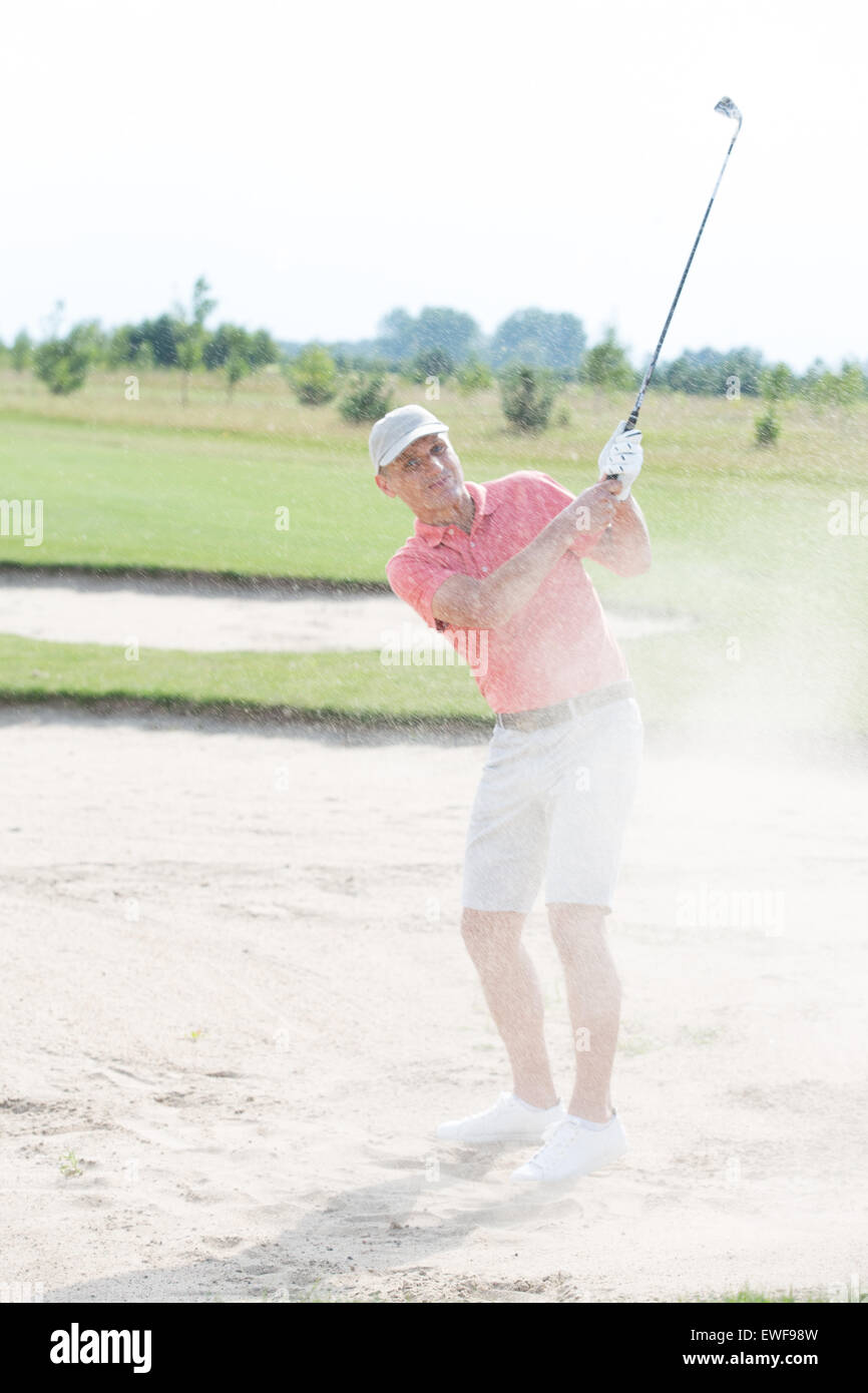 Middle-aged man playing at golf course Stock Photo