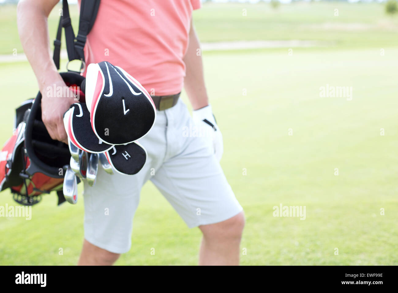 Midsection of man carrying golf club bag at course Stock Photo Alamy