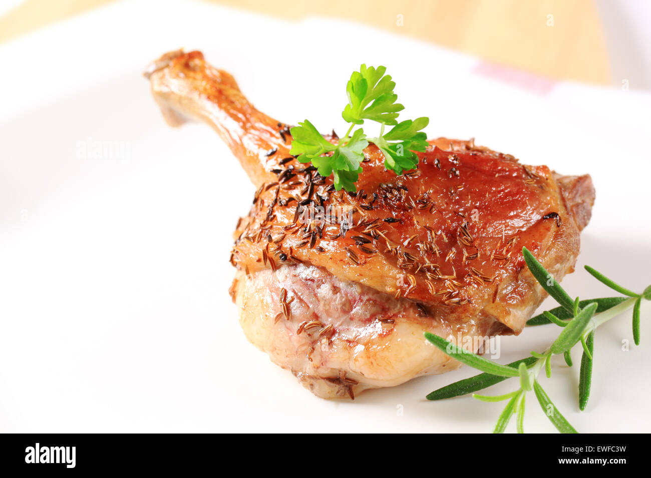 Roast duck leg topped with caraway seeds Stock Photo Alamy