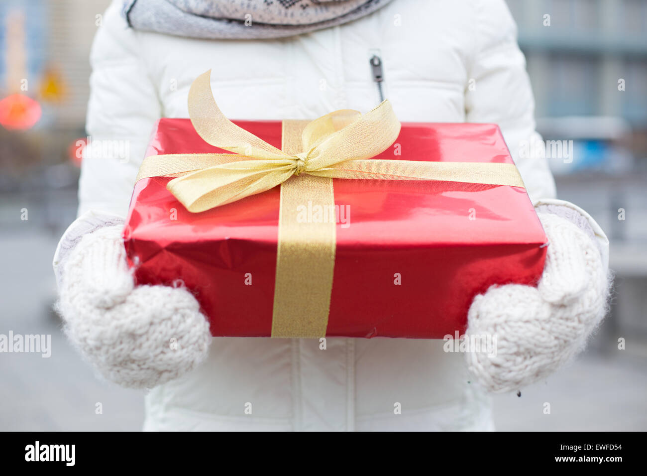 Midsection of woman holding gift box winter Stock Photo