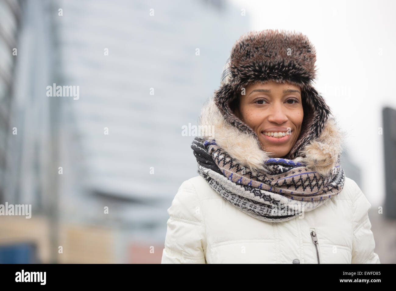 Portrait of happy woman in warm clothing outdoors Stock Photo