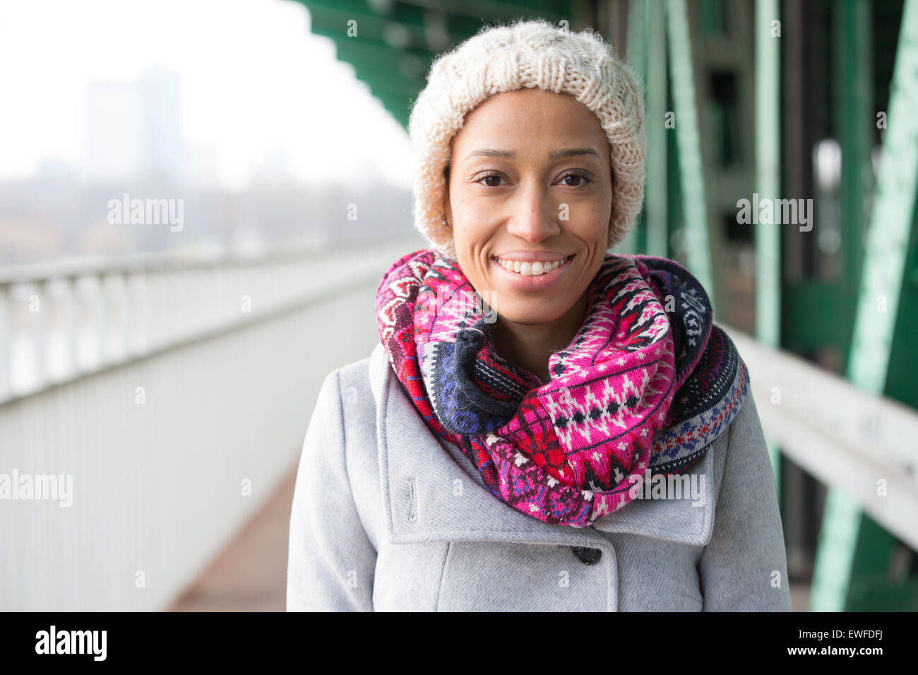 Portrait of happy woman in warm clothing standing outdoors Stock Photo