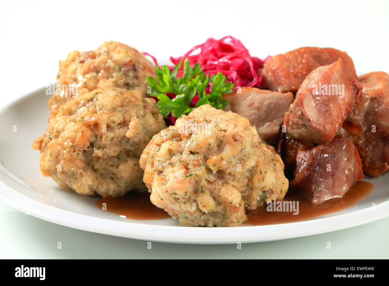Dish of roast pork with Tyrolean dumplings and red kraut Stock Photo