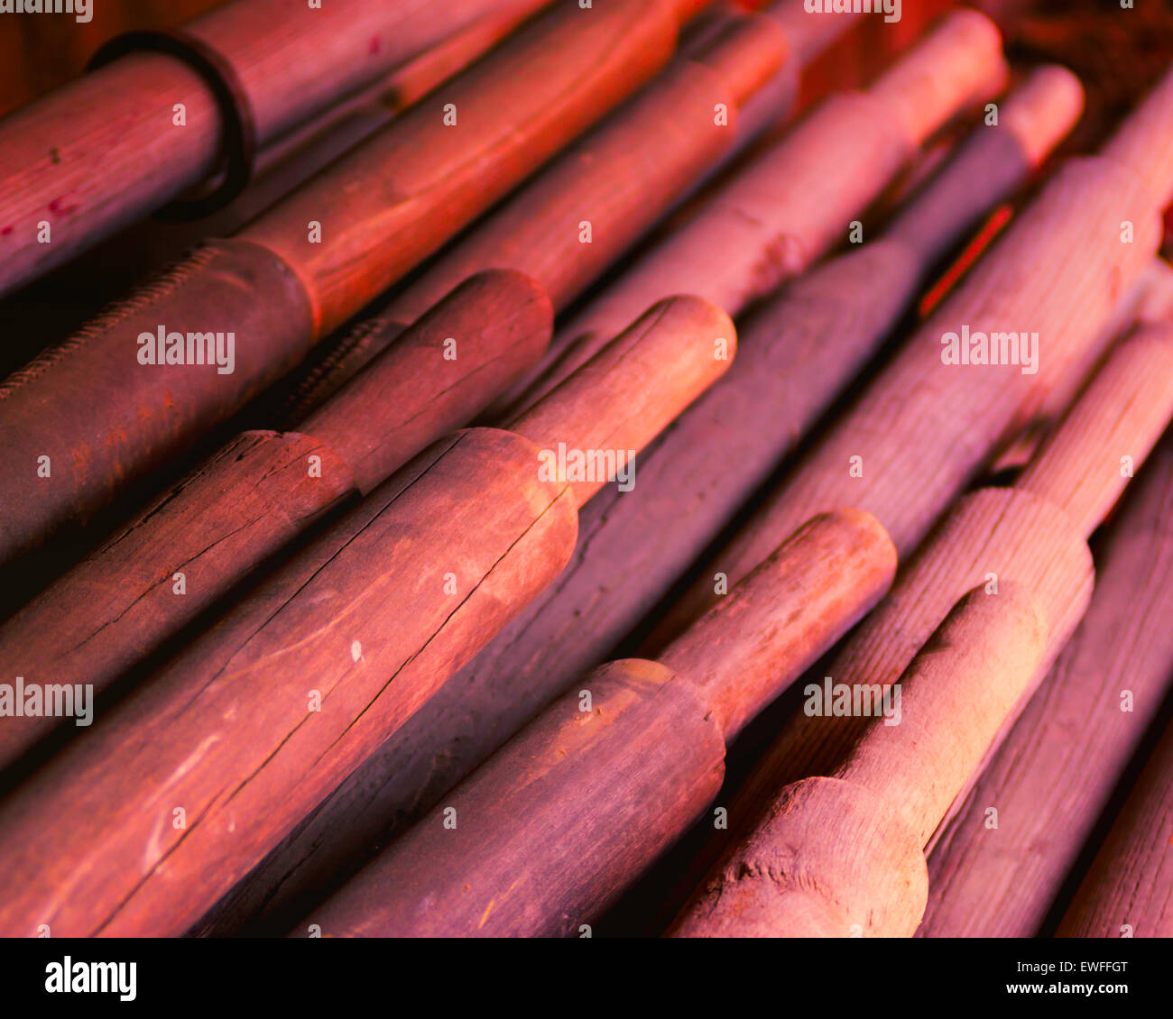 A stack of wooden oars fill this photograph Stock Photo