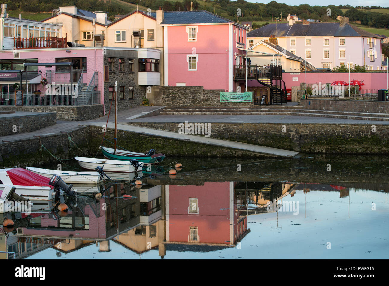 Buildings reflected at sunset in Aberaeron Harbour, Wales. Stock Photo