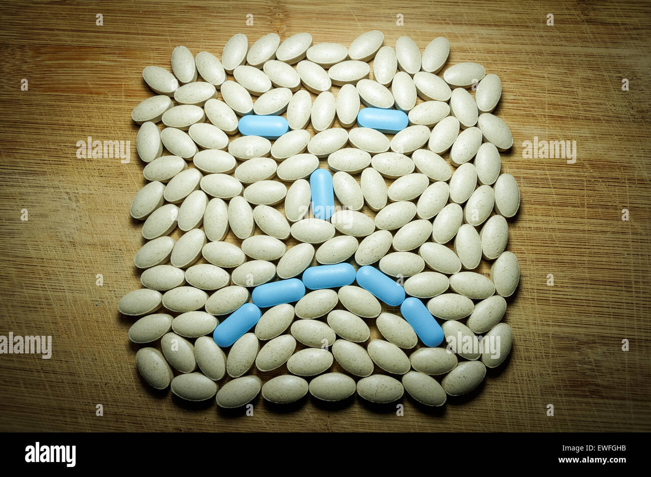 Sad face made out of pills Stock Photo - Alamy