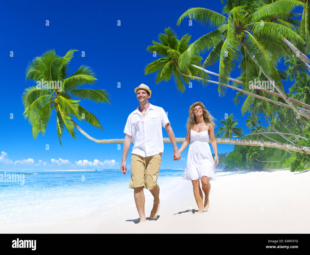 Couple relaxing on the beach Stock Photo - Alamy