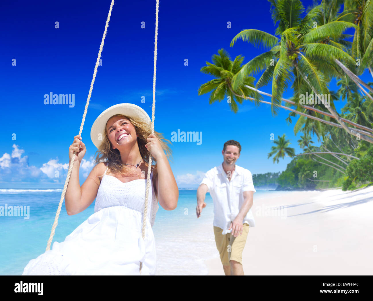 Couple relaxing on the beach Stock Photo - Alamy