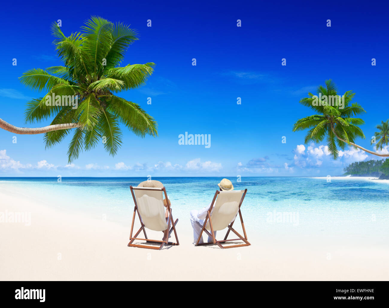 Couple relaxing on the beach Stock Photo - Alamy