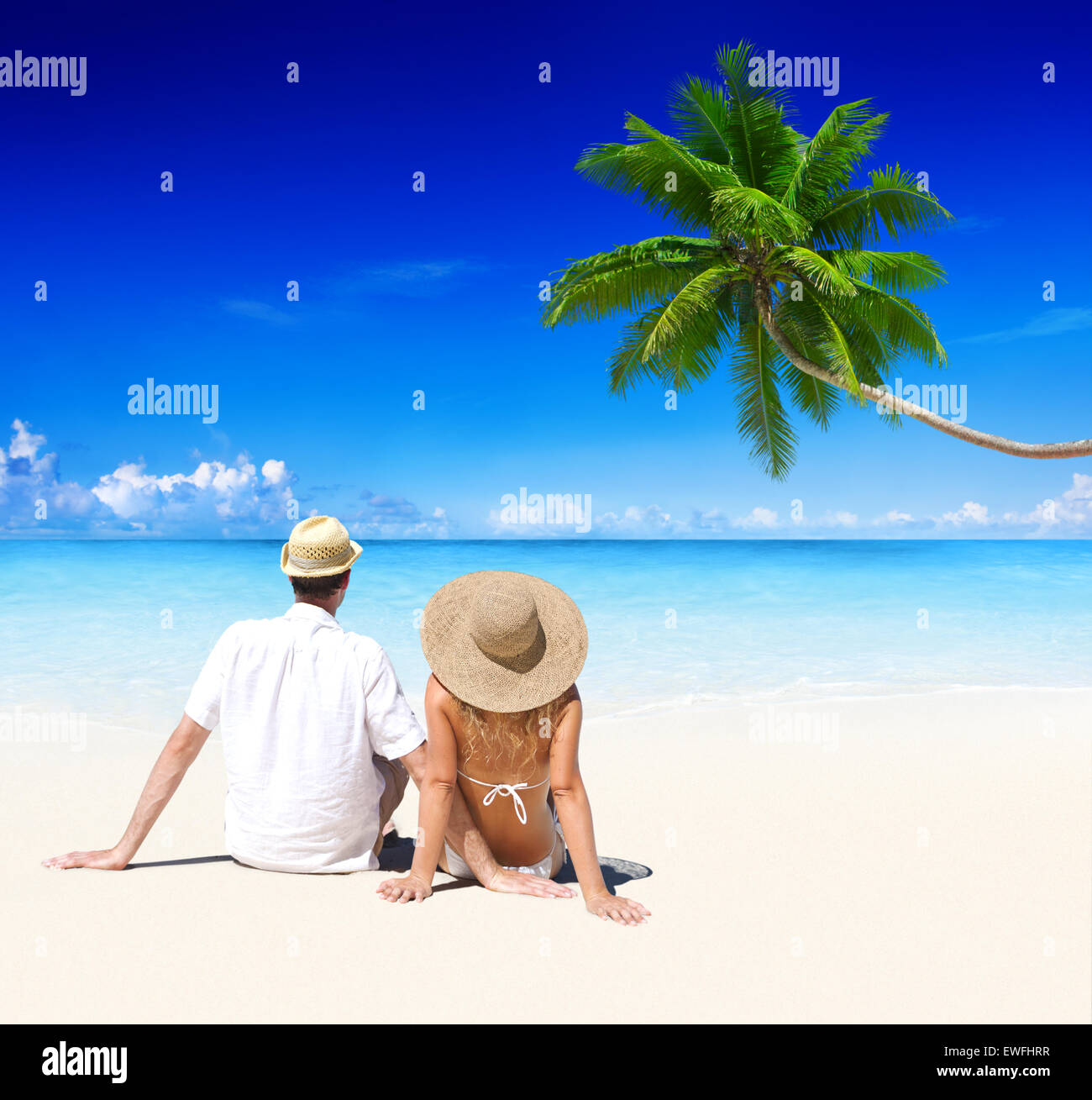 Couple relaxing on the beach Stock Photo - Alamy